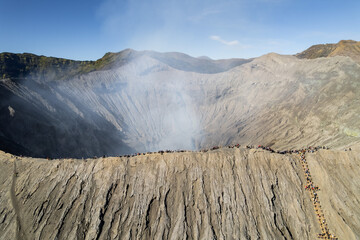 Drone view Tourists exploring the rim of mount bromo crater