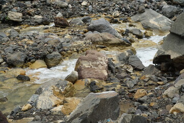 Nature's tranquil stream flowing through rocky terrain landscape wilderness close-up serenity