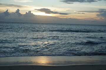 Sunset serenity over ocean waves tropical beach nature photography calm atmosphere wide angle tranquility and beauty