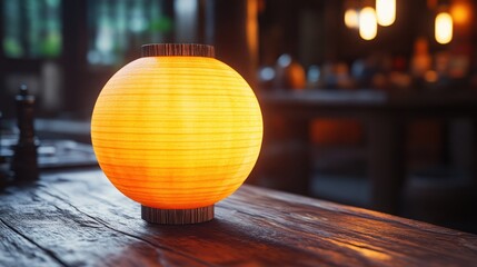 Fototapeta premium Warm-toned paper lantern on wooden table