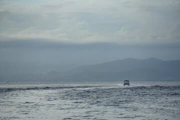 Obraz premium Boat navigating mysterious waters coastal region photography serene environment wide-angle view tranquility of nature