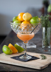 Cocktail with citrus fruit on bar counter