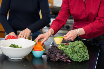Collaborative Meal Prep with Fresh Kale and Measuring Cups