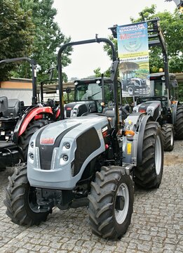 Modern gray Carraro tractor parked on cobblestone, exhibiting power and efficiency