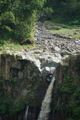 Obraz premium Majestic waterfall cascading down rocky cliff lush green landscape nature photography natural beauty aerial perspective