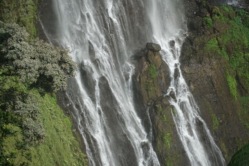 Cascading waterfall scene lush greenery nature photography tranquil environment aerial view serenity concept