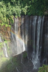 Majestic waterfall cascading down lush green cliffs indonesia nature photography scenic view serenity and beauty