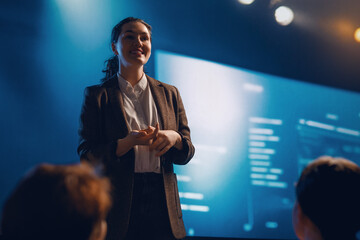 A woman is speaking on stage