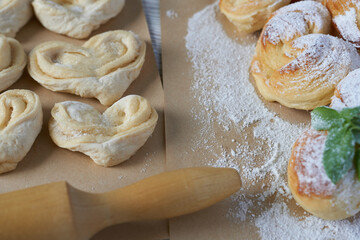 Homemade buns with raisins and powdered sugar on wooden background