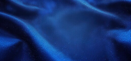 Obraz premium Close-up of smooth, flowing blue fabric with tiny water droplets glistening softly, evoking freshness and calmness