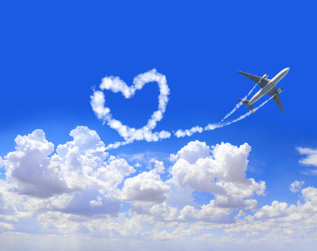 Horizontal background with aircraft. Airplane drawing a heart in sky. Jet flight route of aircraft in shape of a heart in blue sky. Topic of summer holiday, travel, trip abroad on vacation