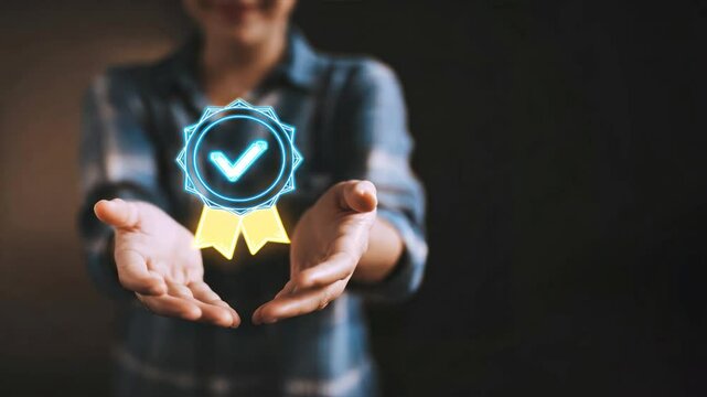 Hands holding virtual hologram of checkmark and ribbon on dark background, showing trusted Iso Certified service, meets ISO standards, quality digital assurance