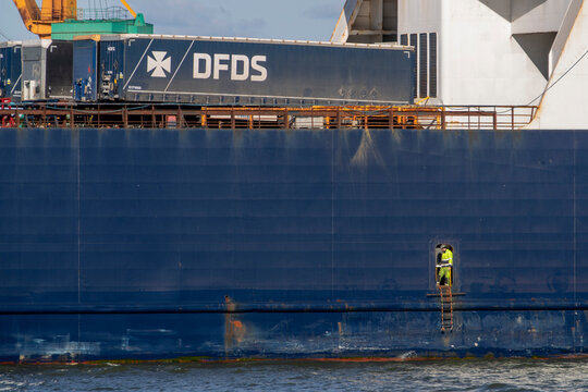 Close-up view of DFDS cargo ship Ark Futura, showing loaded trailers and the ship's side structure with visible rust stains.