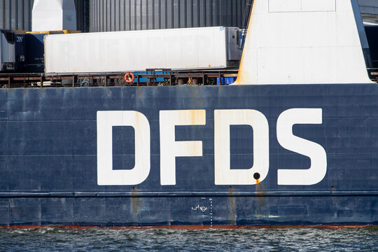 Close-up view of DFDS cargo ship Ark Futura, showing loaded trailers and the ship's side structure with visible rust stains.