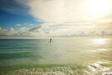 Profile teen girl paddle board summer day Gulf of Mexico