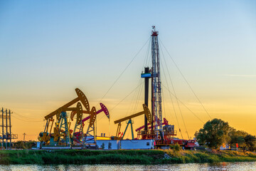 Fototapeta premium Pumping unit and well servicing operations in Daqing Oilfield, Daqing City, Heilongjiang Province, China.