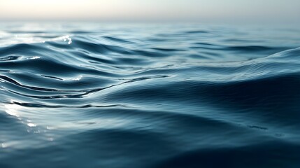 Obraz premium Close-up of gentle ocean waves with soft reflections on calm blue water