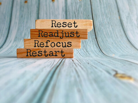 Inspirational Quote - Reset readjust refocus restart text background. Stock photo.