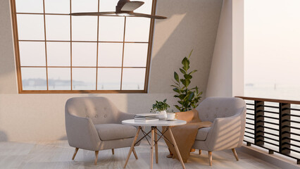 A coffee cup and books on round stool table with fabric armchairs on a terrace of restaurant or cafe