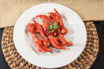 A plate of spicy chicken feet. Spicy and delicious chicken feet dishes