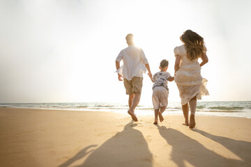Asian family beach vacation. Children parent relax together. People lifestyle.