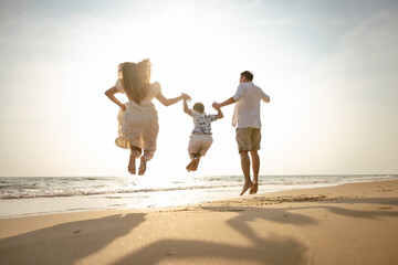 Asian family beach vacation. Children parent relax together. People lifestyle.