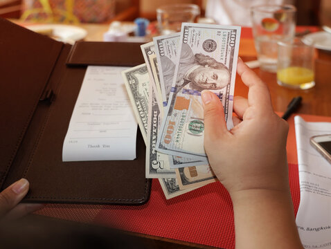 woman hand with a Bill With American Dollars which people, payment and finances concept.
