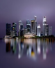 Obraz premium futuristic city skyline illuminated by neon gradient lights, cyberpunk aesthetics, misty atmosphere, high-tech metropolis, glowing reflections, artistic photography, dynamic perspective, cinematic