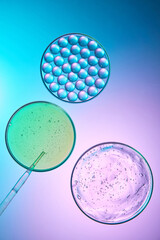Experimental shot of cosmetic essence and liquid modulated from natural ingredients. Round air bubbles floating on the surface of the liquid. Plastic bulb pipette used to pump water or liquid.