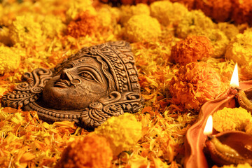 Stunning Goddess Durga with festive marigold flowers and illuminated background.Ideal for Durga Puja, Navratri, Hindu festivals,spirituality, Indian culture, mythology, divine mother, religious events