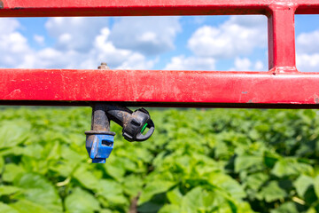 Sprinklers on the bracket of the plant protection sprayer preparing to spray a crop protection...