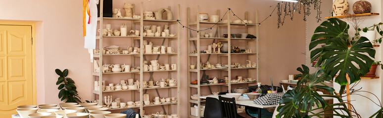 Creative pottery studio filled with artistic pieces and vibrant colors during a sunny afternoon