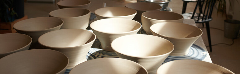 Creating beautiful pottery bowls in a cozy art studio space during a sunny afternoon