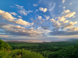 Fototapeta premium Enjoy stunning mountain views under a cloudy sky, surrounded by lush greenery and adventure