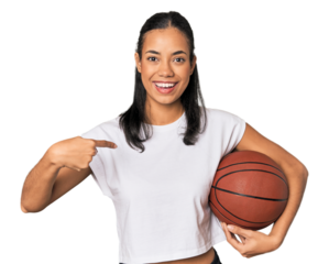 Young Filipino woman with basketball person pointing by hand to a shirt copy space, proud and confident