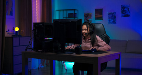 Late at night, a young girl walks into her glowing room, sits at the computer, and logs in. Wearing...