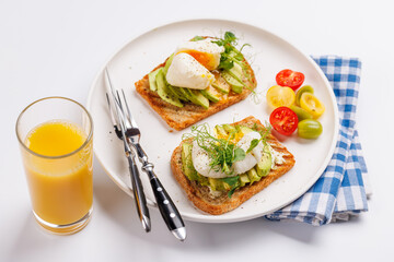 Delicious avocado toasts topped with perfectly cooked poached eggs