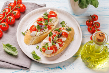 Tasty antipasto toasts featuring classic caprese with mozzarella and tomatoes, and savory prosciutto with herbs