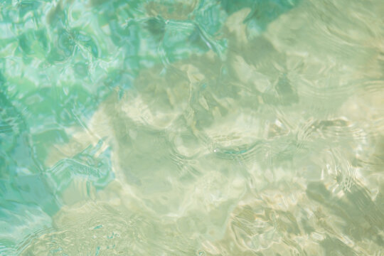 abstract background photo with blue and turquoise swimming pool water surface and ripples in watercolor style