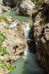 Small waterfall of a stream in sunny nature
