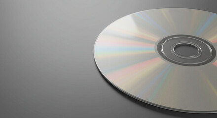 CD disk is lying on the right on a gray background