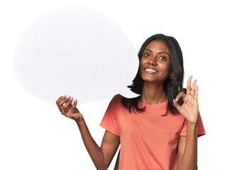 Indian woman with dialogue bubble cheerful and confident showing ok gesture.