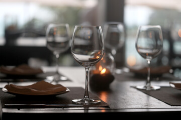 table setting in the restaurant, glasses and cutlery, a clean new table in the restaurant is waiting for guests, a free table