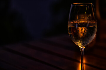 a glass of cold white wine and serving in the restaurant