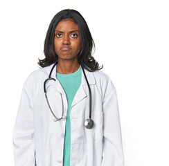 Young Indian doctor with stethoscope sad, serious face, feeling miserable and displeased.