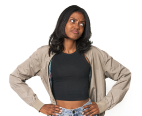 Portrait of a young Indian woman confused, feels doubtful and unsure.