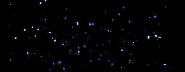 Panoramic blue blurred fire embers sparks on black background . Texture isolated overlays. Concept of particles, sparkles, flame and light.