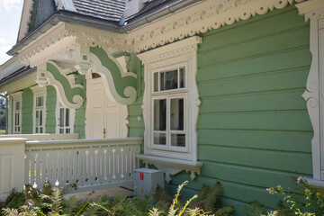 A green house with white trim and a white door