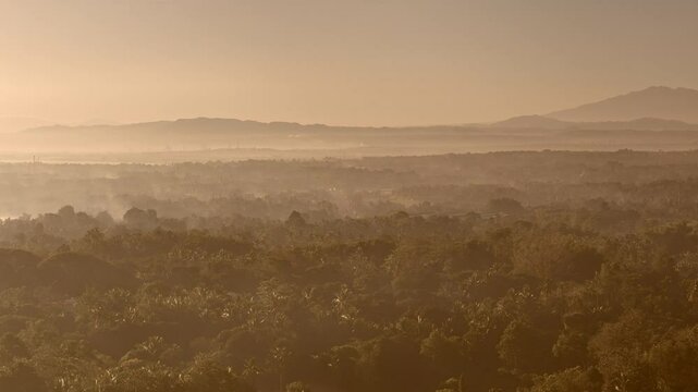Panoramic aerial view at dawn reveals Cagayan de Oro&rsquo;s mist‑covered cityscape in Mindanao, Philippines, bathed in soft early morning light.