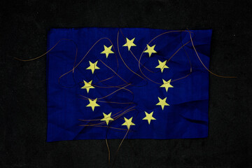 Energy Crisis in the European Union. Chaotic copper threads on the dark EU flag 
symbolize...